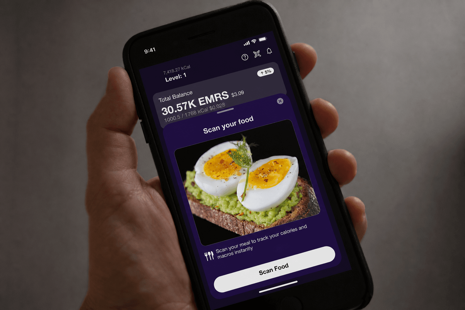 A person holding a phone with the Emorya food scanner app scanning avocado eggs on toast